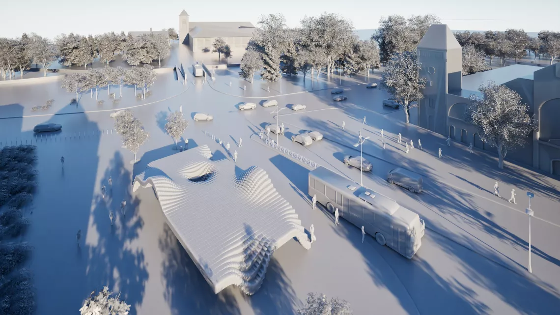 Widok z góry na przstanek w formie pofalowanej konstrukcji, przy którym stoi autobus. Na planie widoczny jest ruch uliczny, drzewa i budynki.