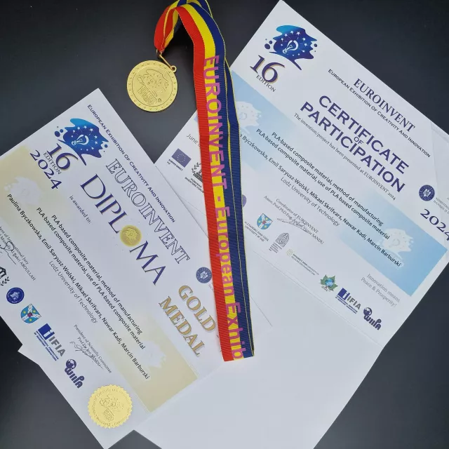 Złoty medal i dyplom  pokazane na czarnym tle